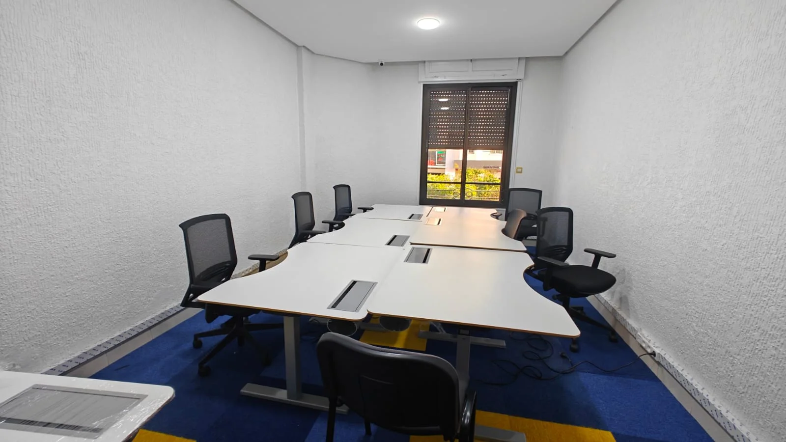 The eight shared ergonomic workstations at The Travel Hub
